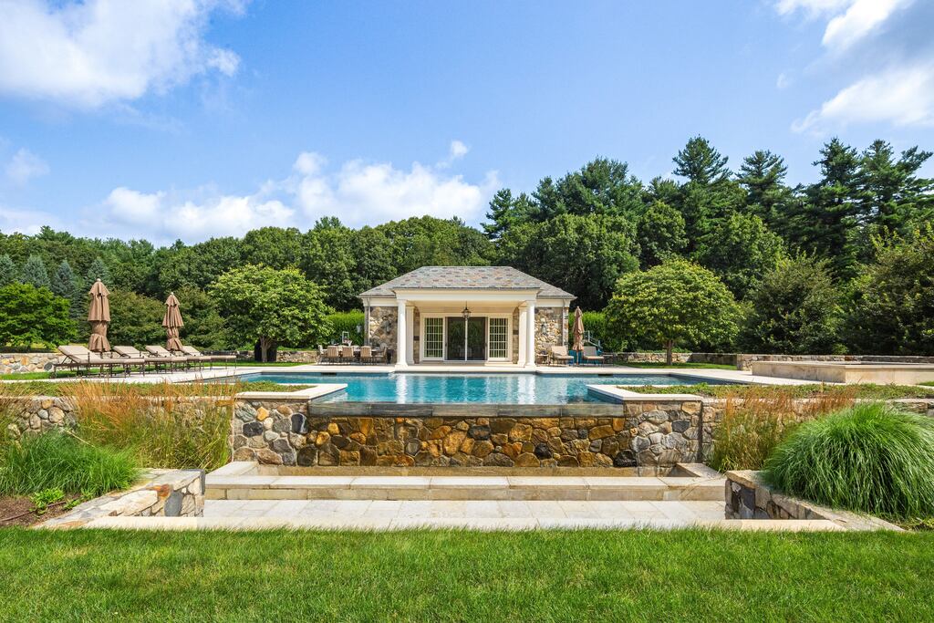 Another view of the swimming pool and pool house.
