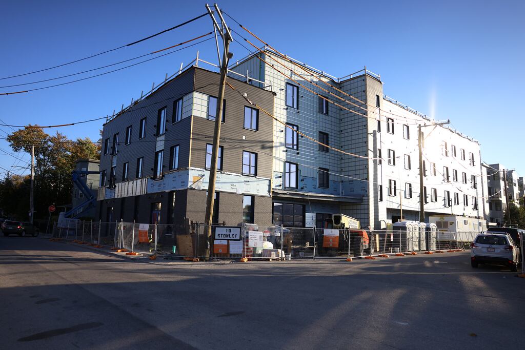 An apartment building under construction in Jamaica Plain last year. New construction has slowed in Boston amid higher interest rates and materials costs. Mayoral challenger Josh Kraft has said he'd lower affordable housing requirements to help boost new projects.