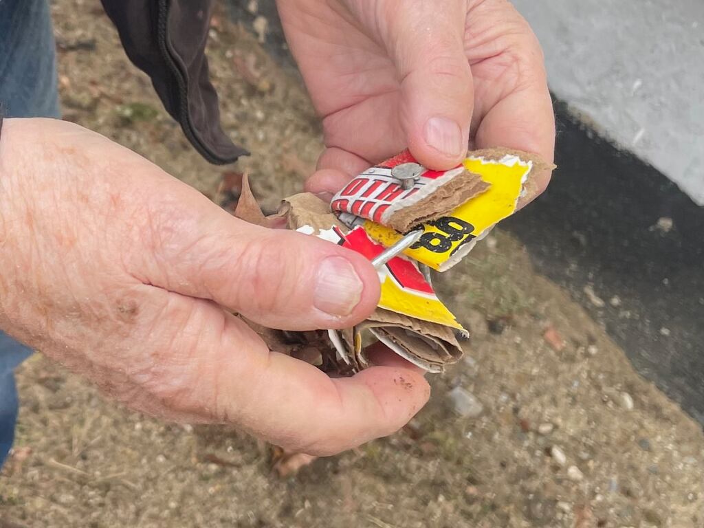 Donald S. Fife holds the nails and cardboard that he suspects were used to damage the foundation of his house in Warwick, R.I.