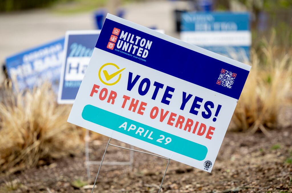 Signs supporting a tax override are displayed in yards on Central Avenue in Milton. Residents head to the polls on Tuesday on whether to raise their property taxes. 