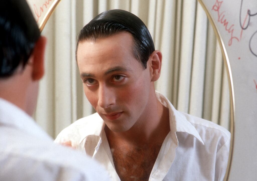 Actor Paul Reubens transforms himself in the mirror into his character Pee-wee Herman in May 1980 in Los Angeles. 