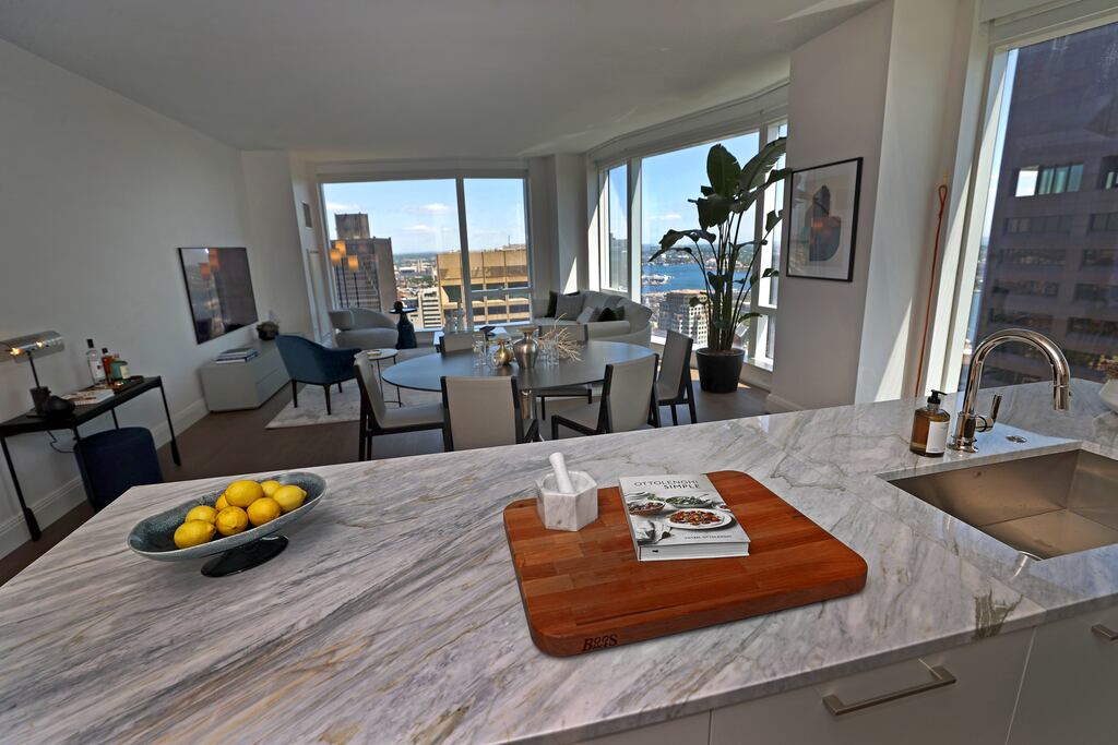 The kitchen, dining, and living area at the Millennium Residences at Winthrop Center.