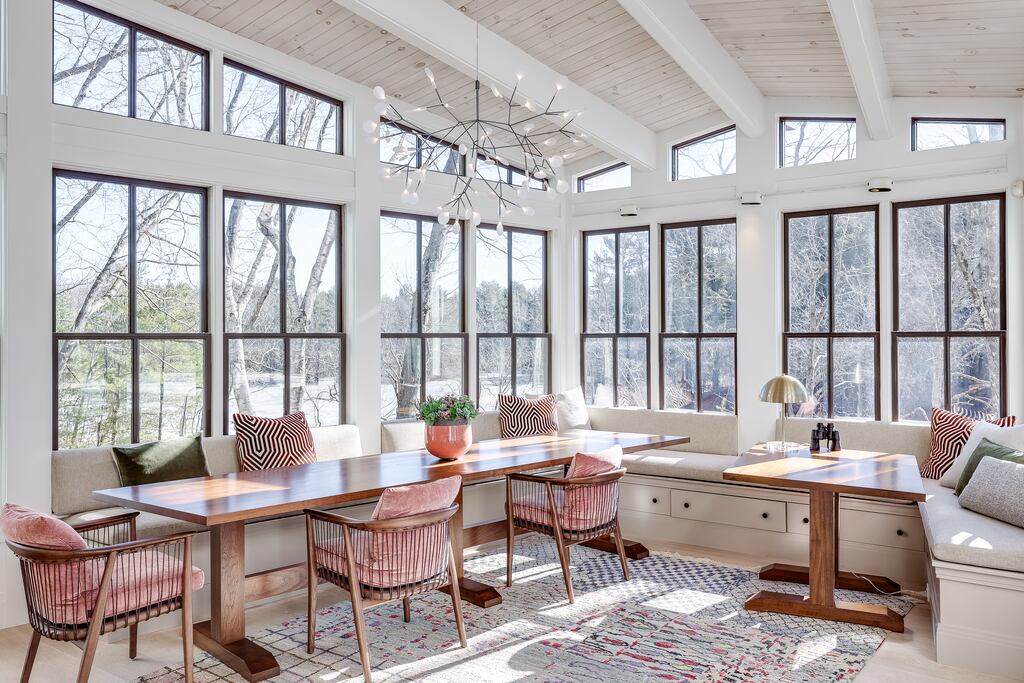 Enormous windows frame a seating area in the Concord home. 