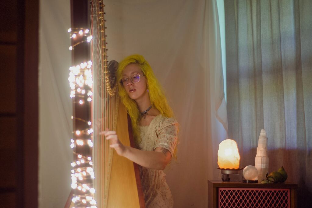 Harpist Emma Newton performs in Rhode Island under the stage name Space Cowboy Newt.