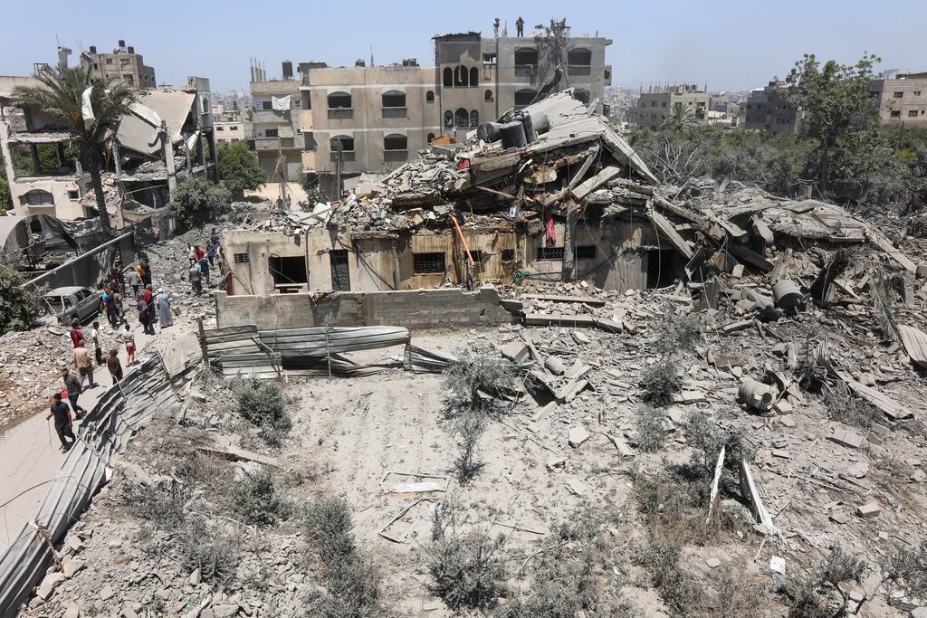 Palestinians inspected the rubble following Israeli strikes on the al-Qattaa family home in the al-Tuffah neighborhood in Gaza City, on Saturady.