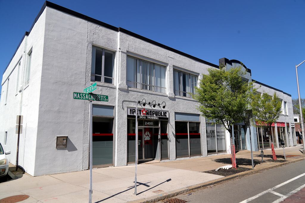 This squat building at 2400 Mass. Ave. in Cambridge is set to be replaced with a 60-unit condominium building, but the project is stalled amid difficult financing.
