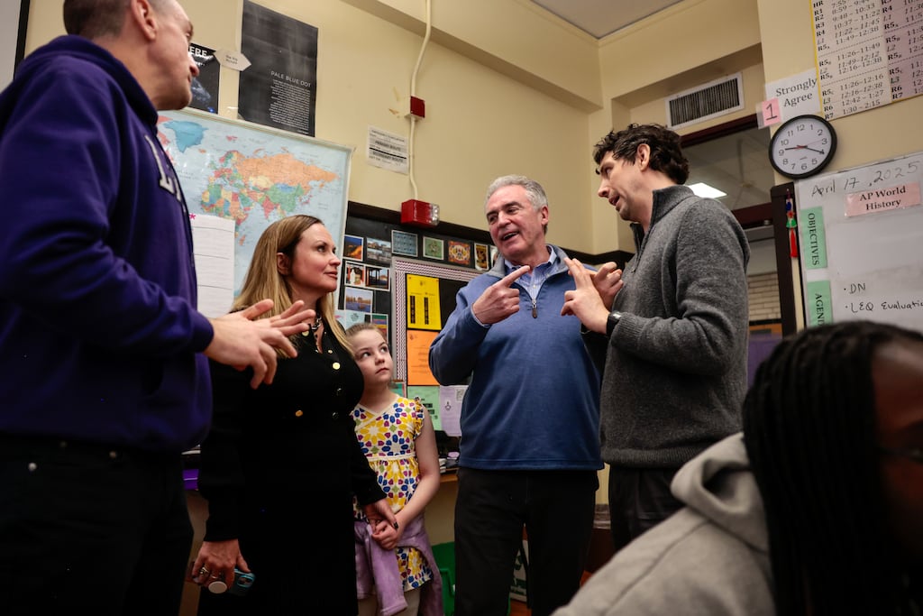 From left to right: Jason Gallagher, head of school at Boston Latin School, Katherine Craven, chief administrative and financial officer at Babson College, her daughter Fianna, and James E. Rooney. president and CEO at Greater Boston Chamber of Commerce, talk with teacher Noah Finegan during his Spanish class at Boston Latin School on April 17.