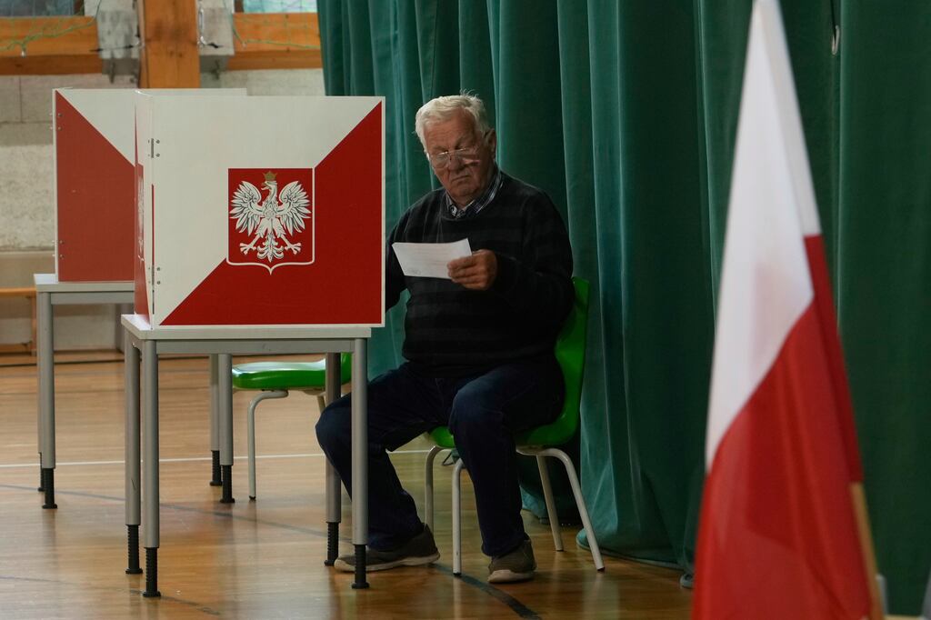 A resident prepared to cast his vote during the presidential election runoff in Warsaw, Poland, Sunday.
