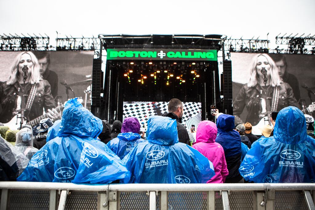 Poncho-clad fans took in a performance by Sheryl Crow at Boston Calling on Friday.