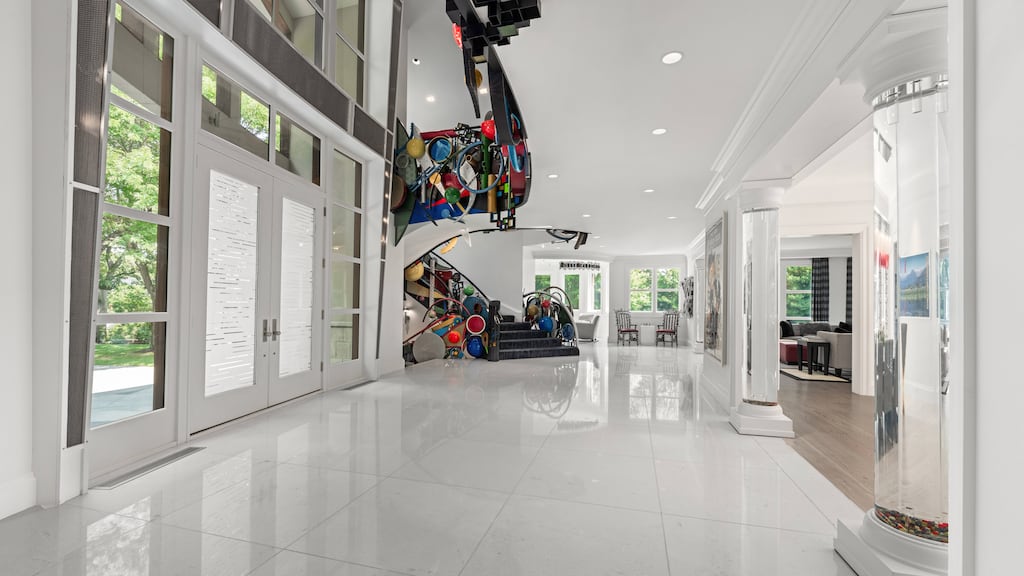The master staircase features contemporary art.