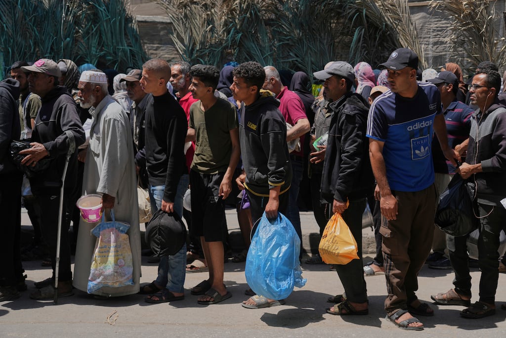 Palestinians lined up for food distribution in Deir al-Balah, Gaza Strip, on Friday. Israel's nearly three-month blockade on Gaza has pushed the population of over 2 million to the brink of famine.