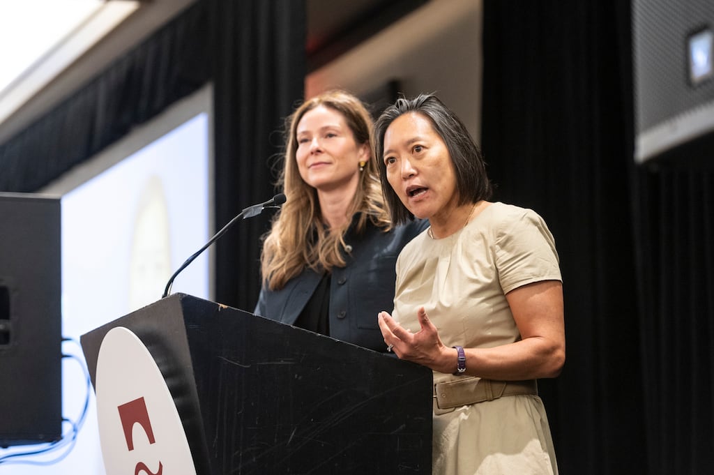 Former economic development secretary Yvonne Hao speaks to the Charles River Regional Chamber on May 14. She is at the podium with Ashley Stolba, the state's current interim economic development secretary.