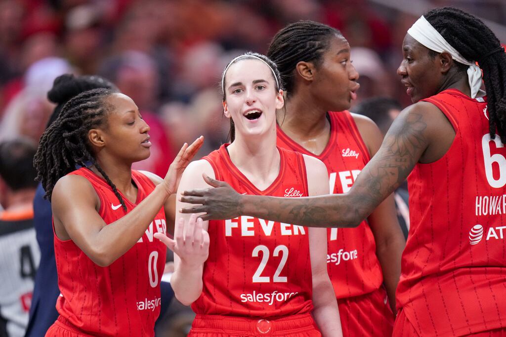 Caitlin Clark is ushered back to the bench area by Fever teammates after being called for a flagrant foul on Sky forward Angel Reese last Saturday.