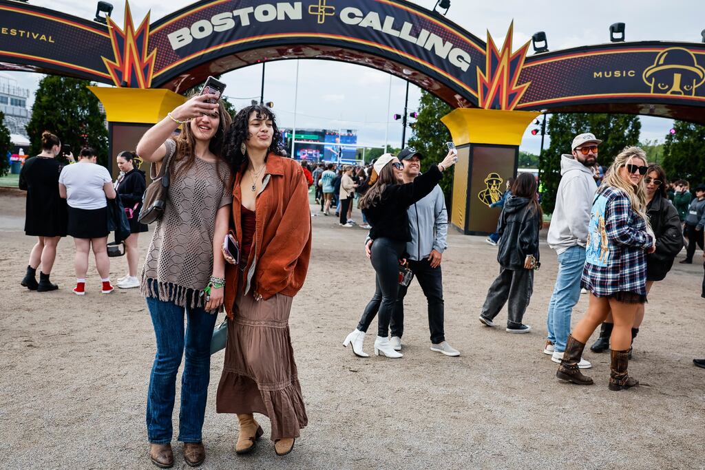 Festival-goers take a selfie under the Boston Calling entrance arch at Harvard Athletic Complex in Boston on Saturday.