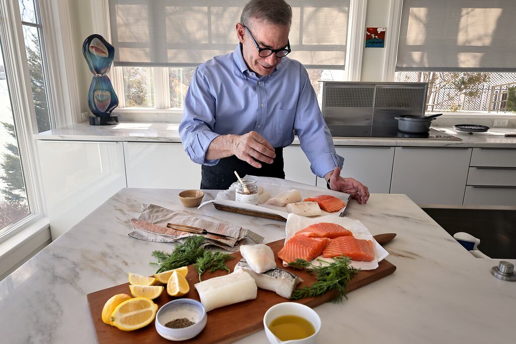 Roger Berkowitz seasoned fish in his Nahant kitchen in 2023. Berkowitz — the former owner of Legal Sea Foods who now runs Roger’s Fish Co. — said tariffs will have a minimal impact on his business, but he’s not pleased with President Trump’s chaotic approach to the economy.