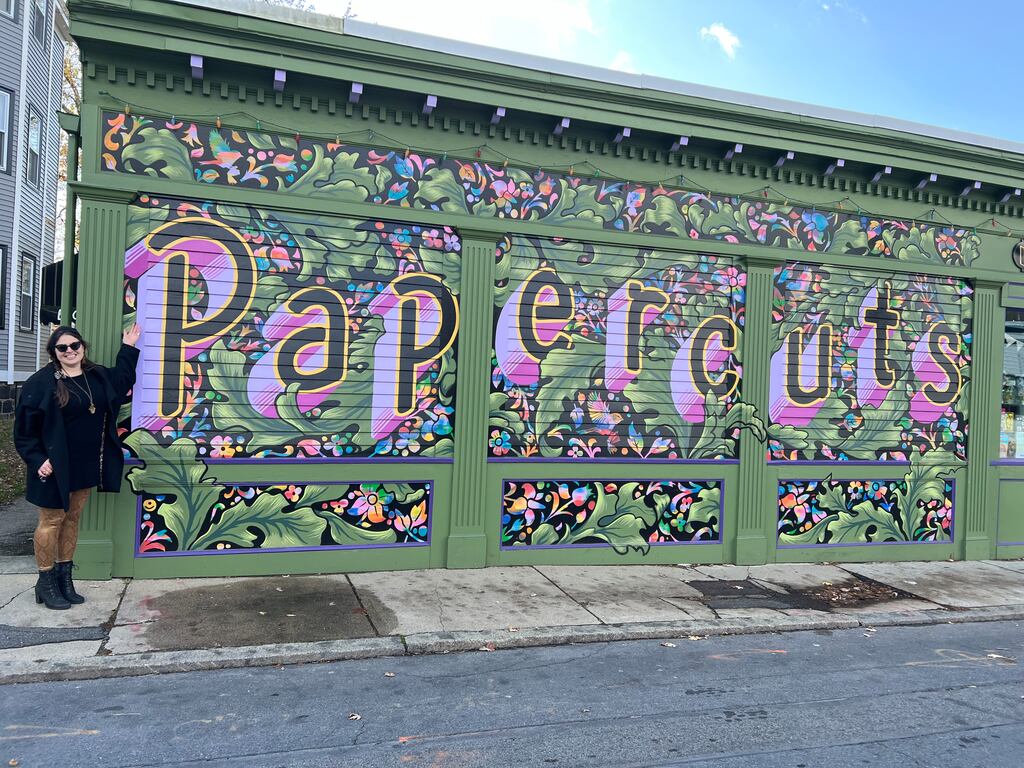 Papercuts Bookshop owner Kate Layte, stands outside the Jamaica Plain locale.