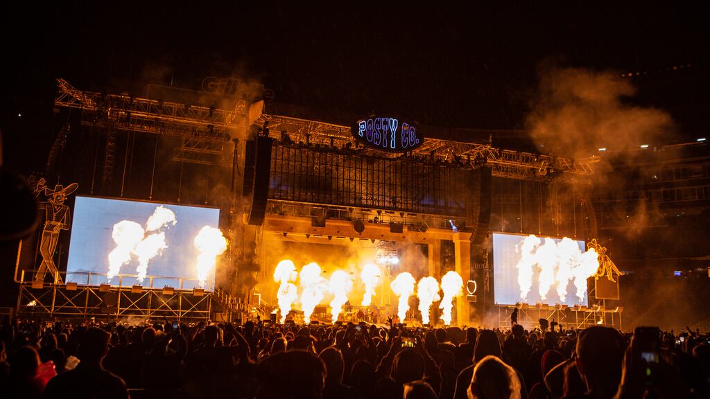Pyrotechnics light up the crowd during Post Malone's performance at Gillette Stadium.