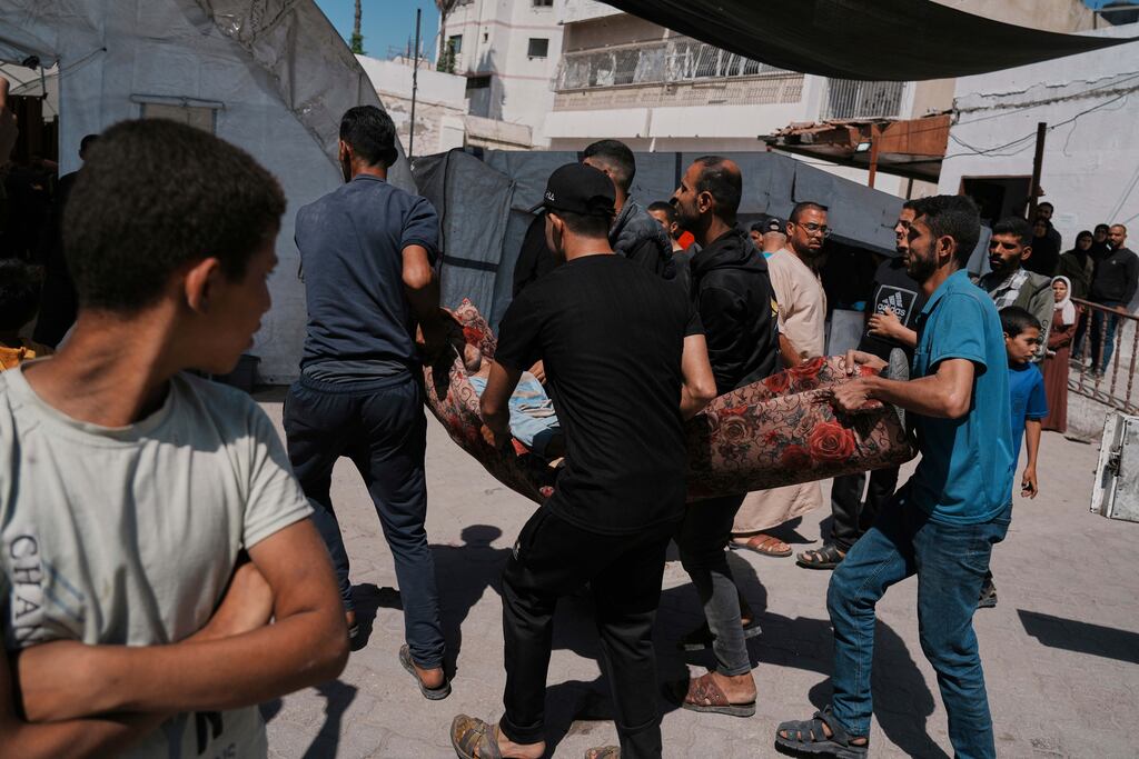 A Palestinian, who was injured in an Israeli airstrike, is brought for treatment at the Baptist Hospital in Gaza City on Friday.