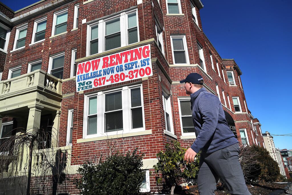Rental broker Thomas Macdonald arrives at an apartment building in Allston.